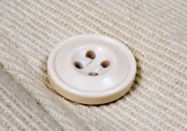 A shell-look polyester button on corduroy