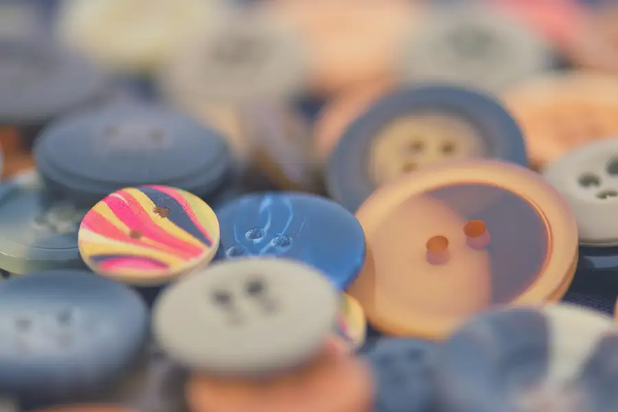 Recycled polyester buttons in blue, ochre and marbled colours