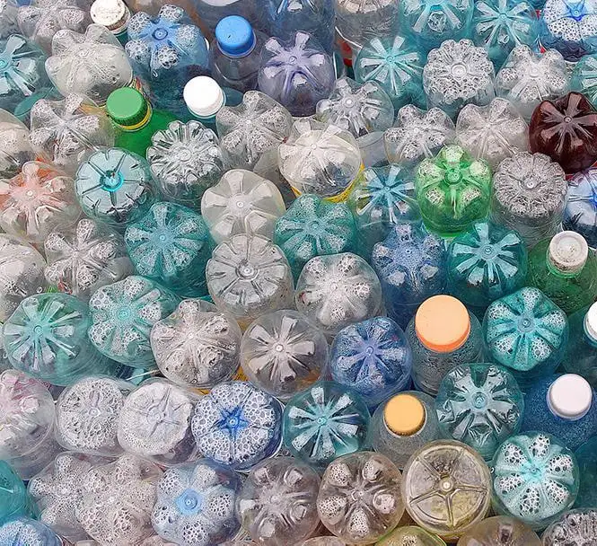 Post-consumer PET bottles seen from below