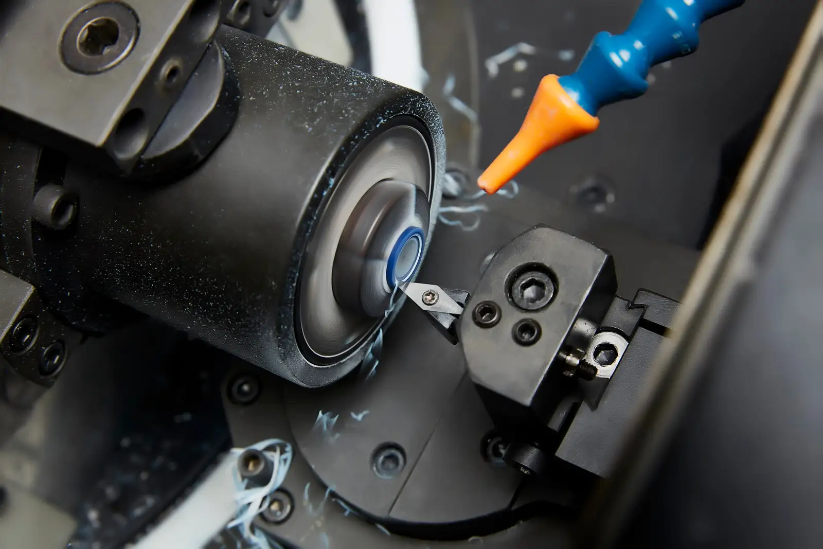 Close-up of a turning machine cutting a button profile